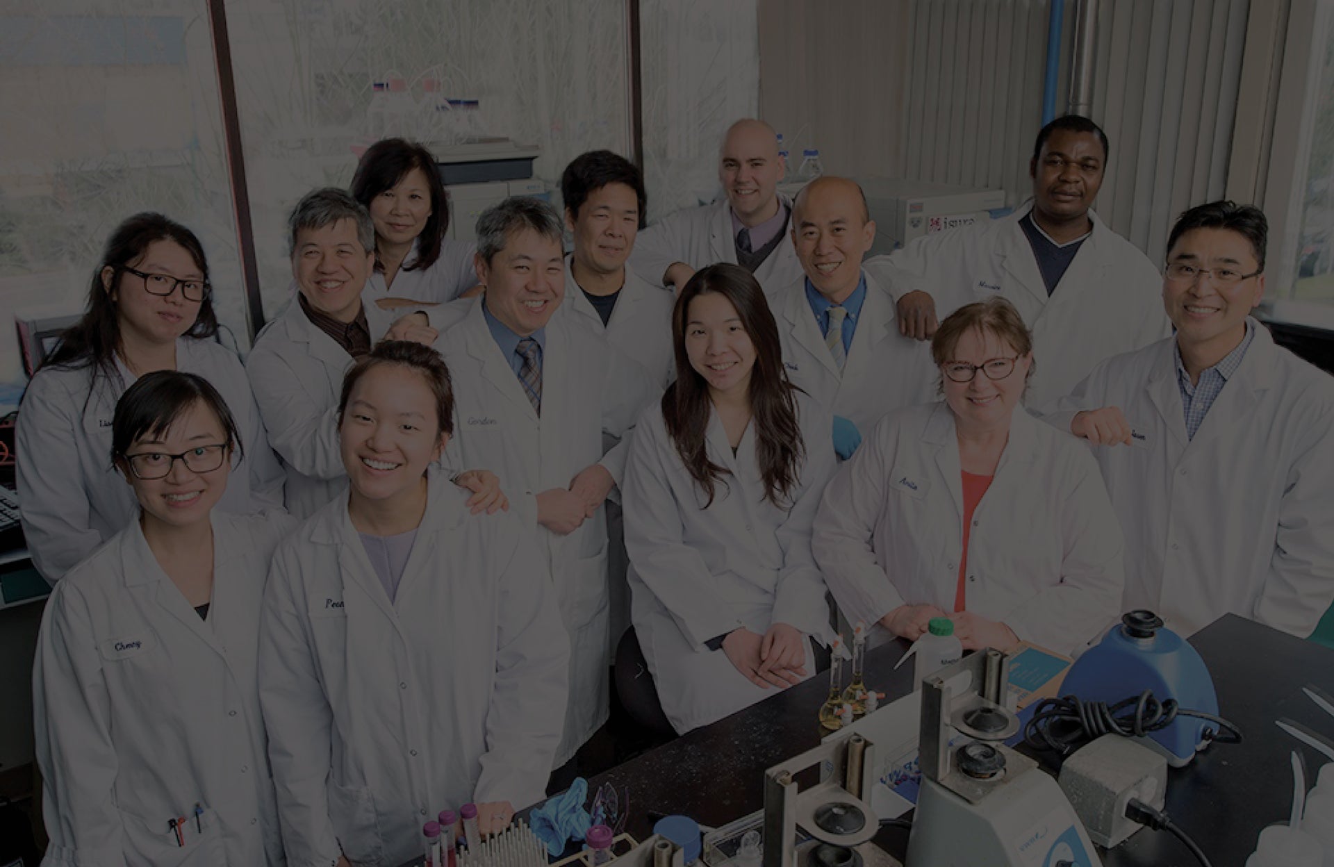 group of people wearing white lab coats in a lab
